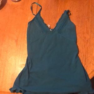 blue shirt with some ruffles on it